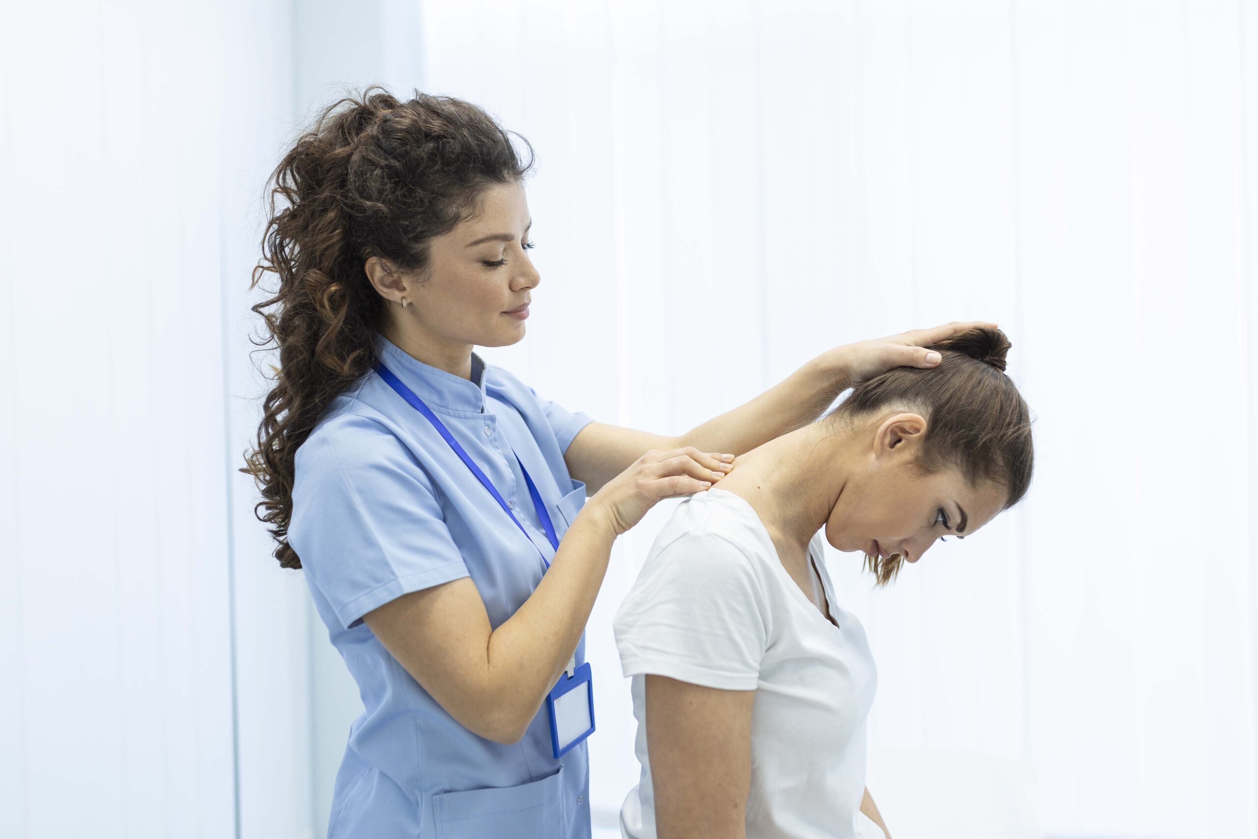 Physiotherapist doing healing treatment on womans neck,Chiropractic adjustment, pain relief concept.office syndrome